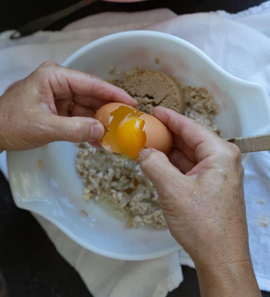 adding eggs, brown sugar, and oil to oatmeal mixture