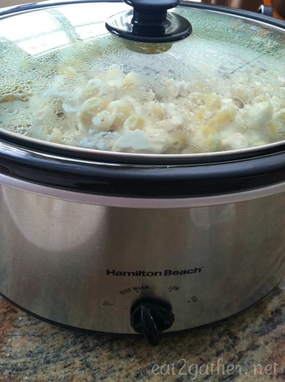 crockpot with steamy lid cooking alfredo