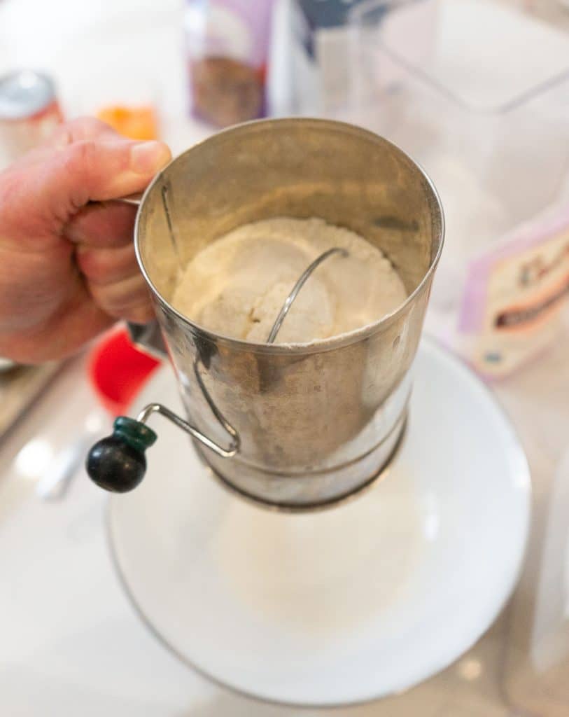 sifting flour sugar and salt together over mixing bowl