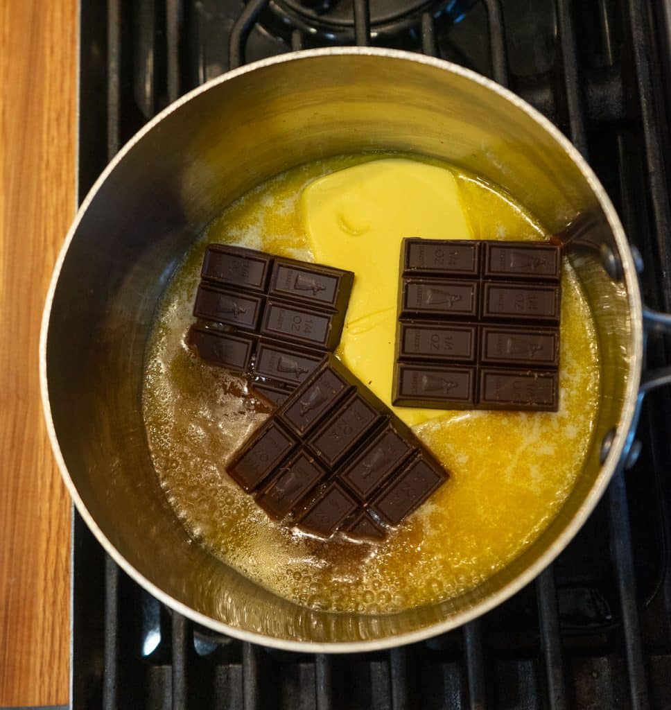 butter and germans bakers chocolate bars melting in saucepan on stove top