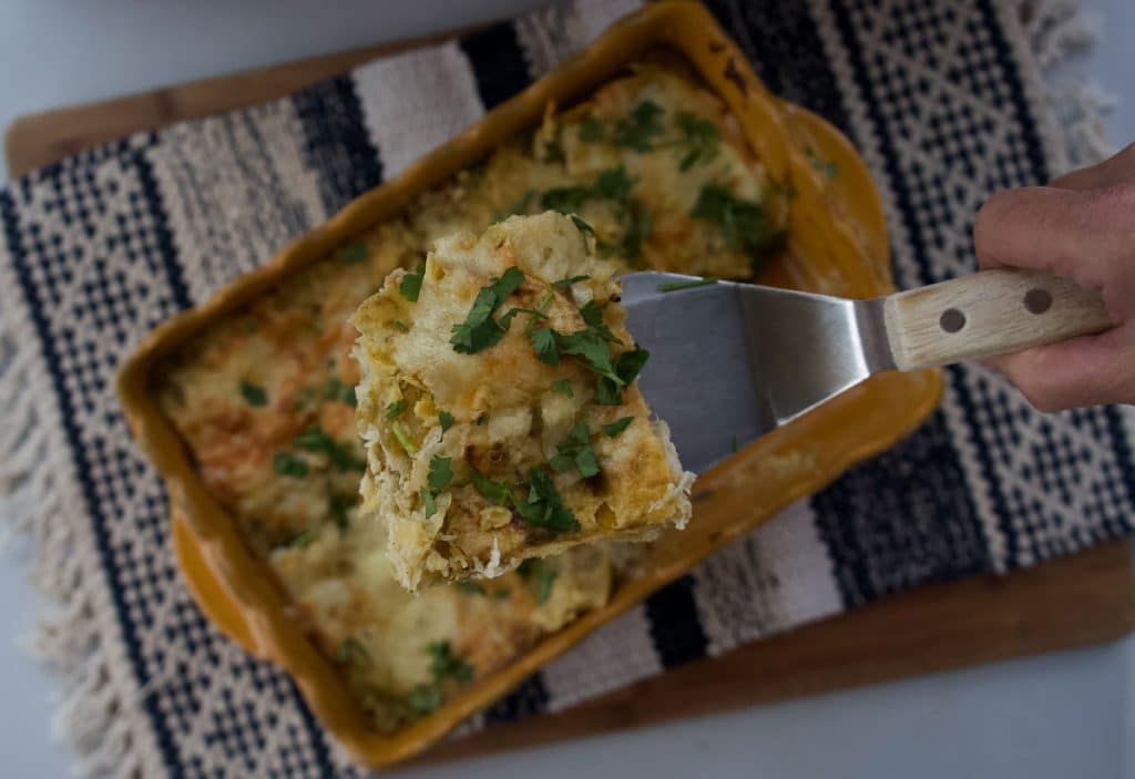 IMG_6023 a spatula lifting a piece of enchiladas verde out of the baking dish