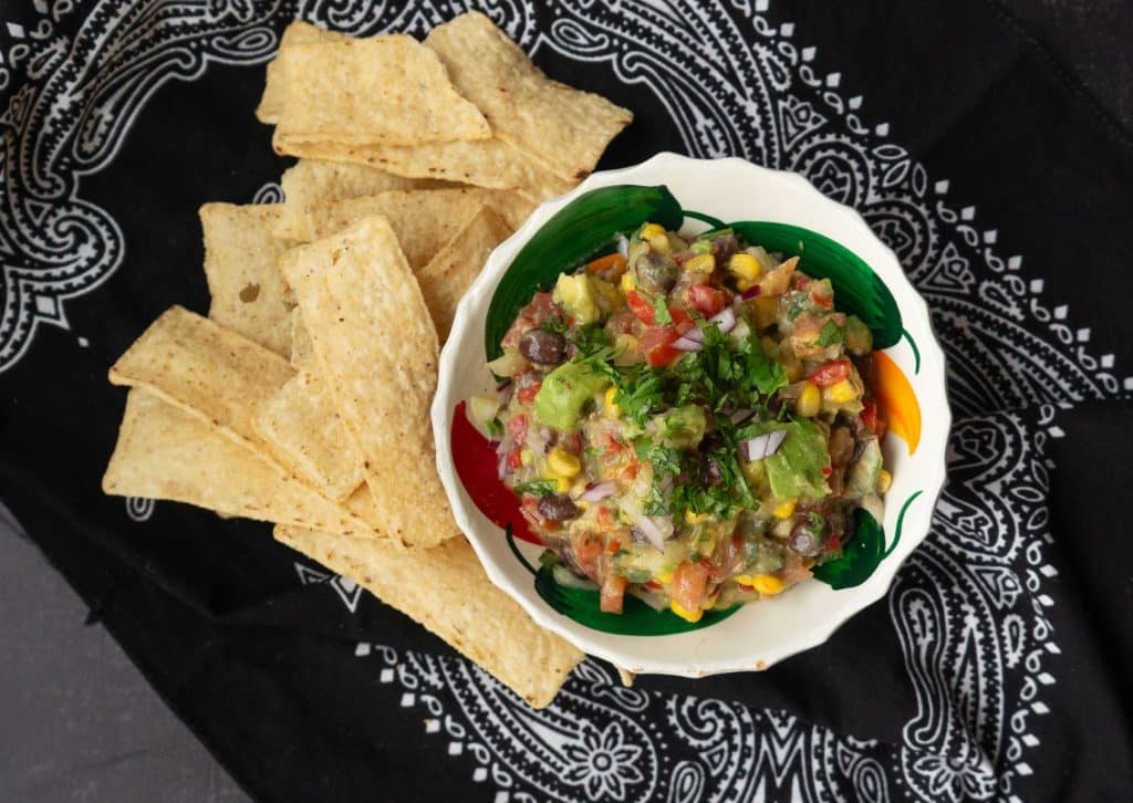IMG_6727 a dish of cowboy caviar with chips on the side on a black bandana
