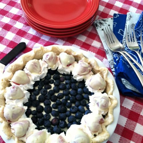 Red White and Blue pie on a red checker board table cloth with red plates, blue napkins and forks