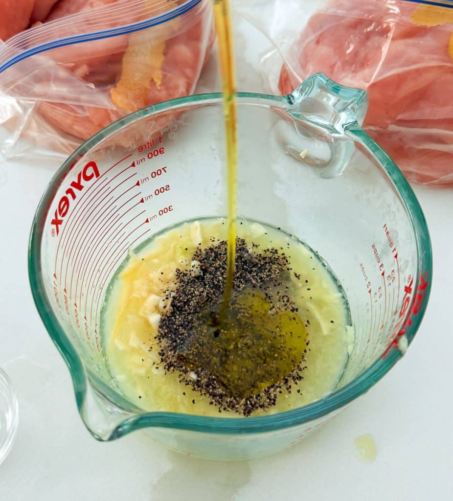 mixing marinade in a large glass measuring cup
