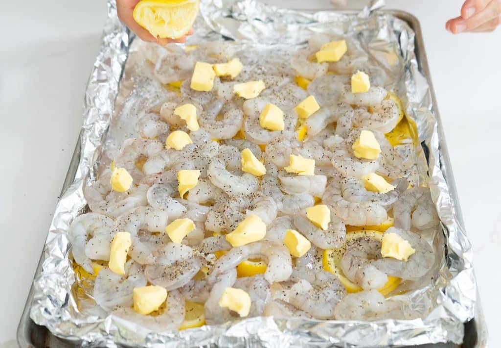layering the butter on top of the shrimp