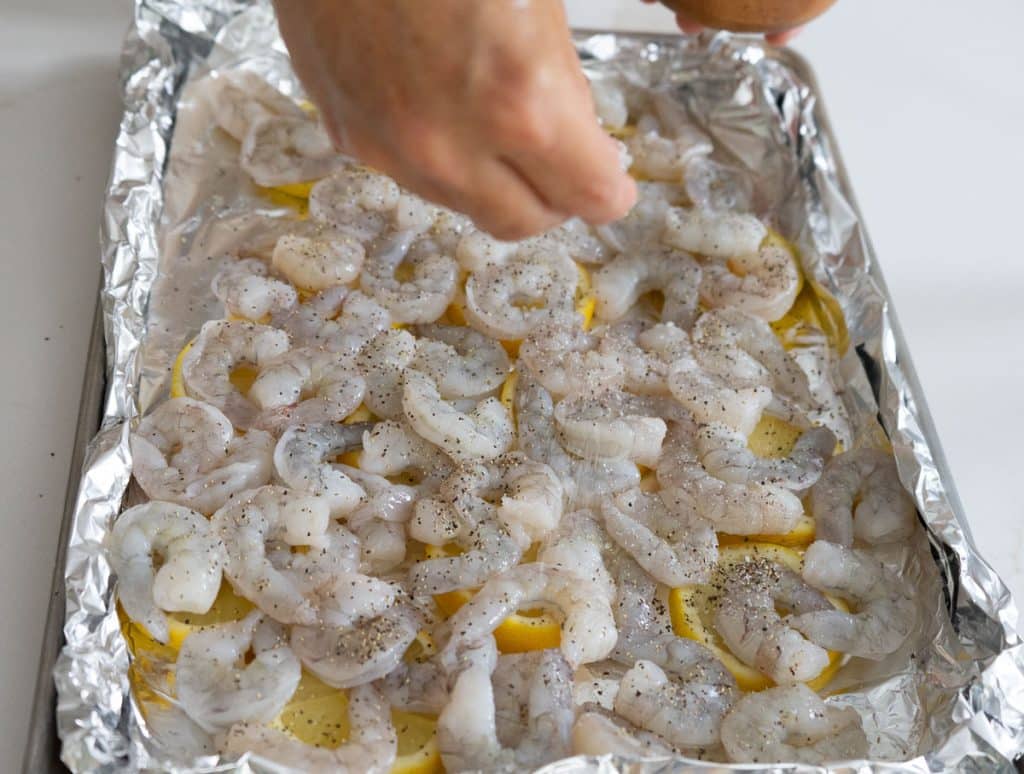 layering shrimp on top of the lemons