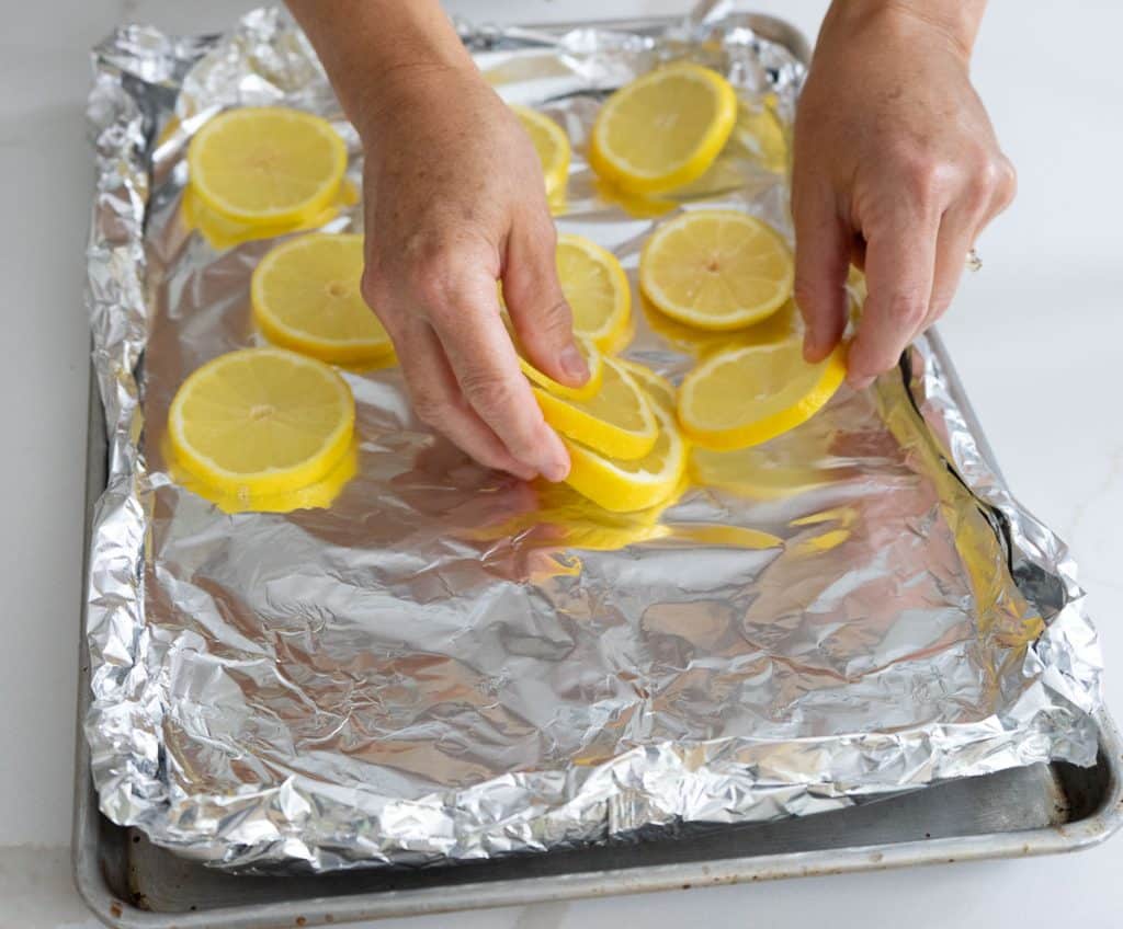 laying lemons on to a foil lined cutting board