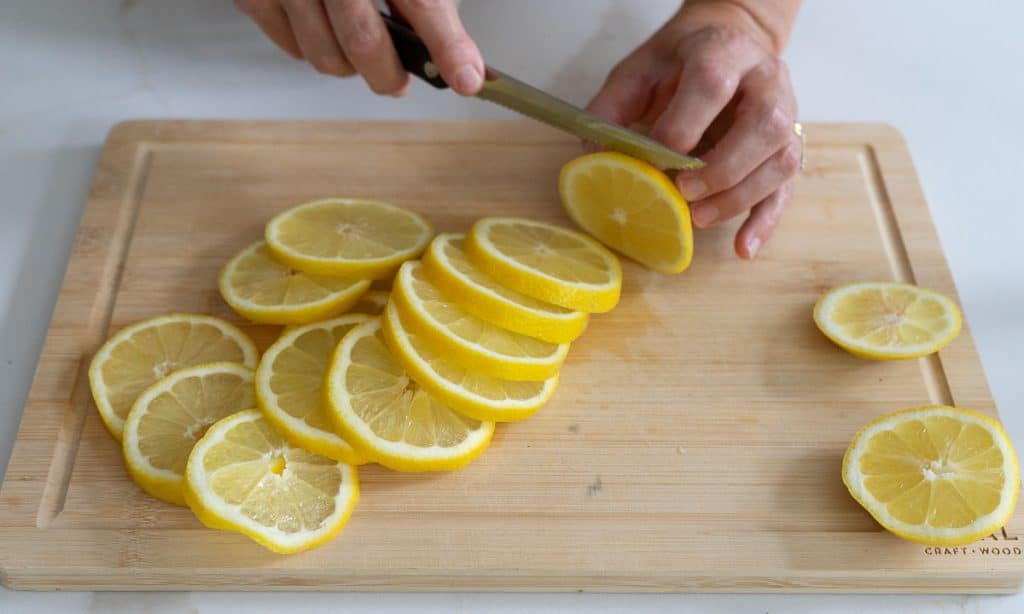 slicing lemons on wood cutting board
