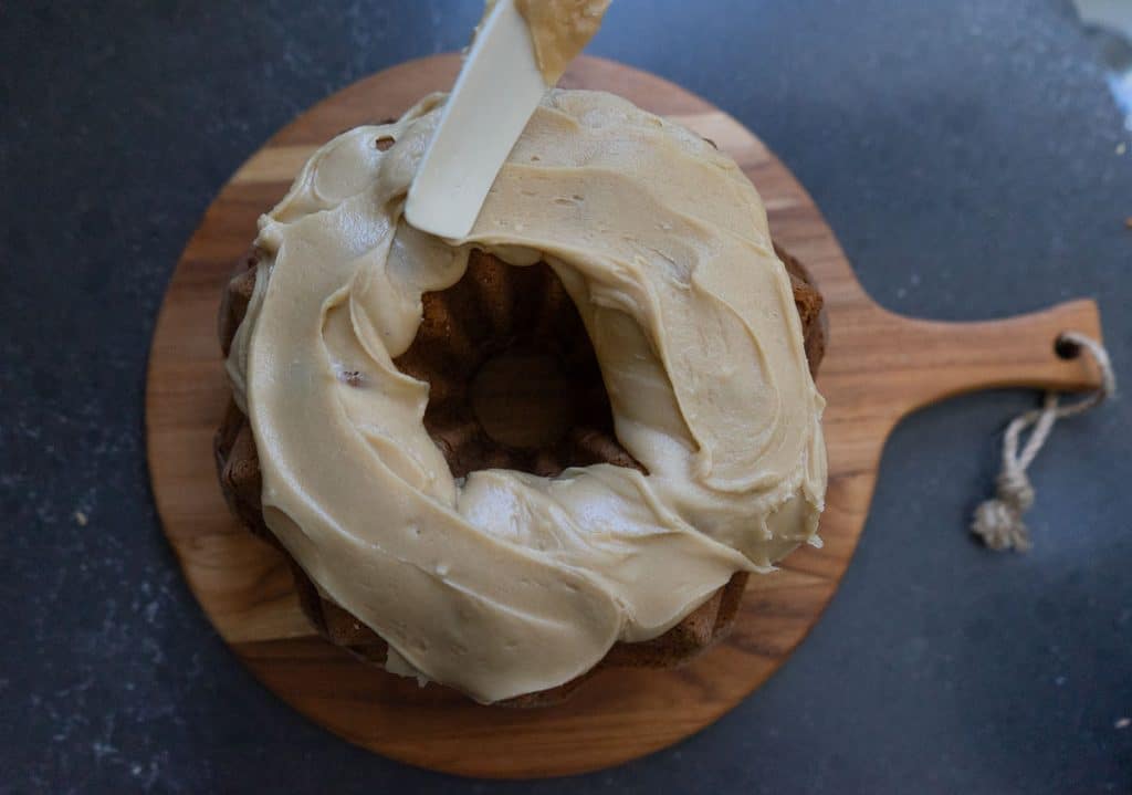 Spread frosting over top of bundt cake. 