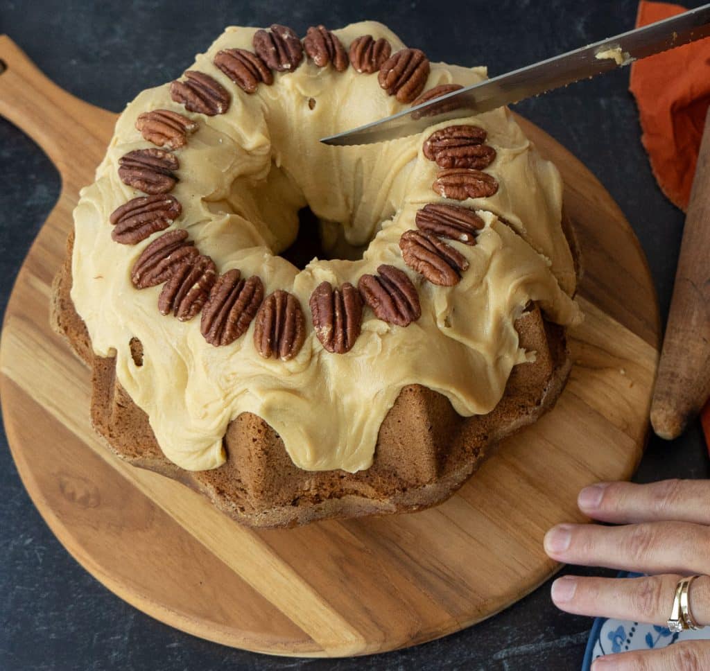 cutting into caramel pumpkin bundt cake
