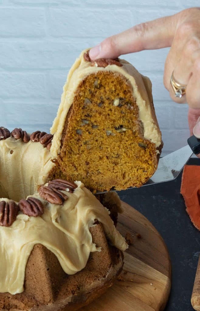 Holding a piece of cut cake over 