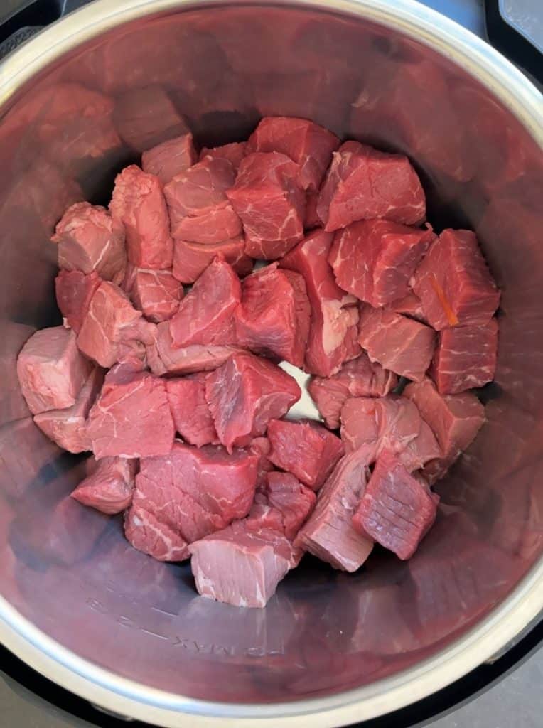 cut up stew meat in the bottom of an instant pot