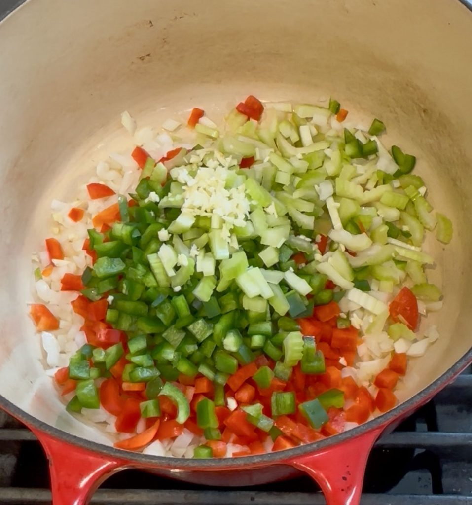 onions, celery, peppers, and garlic sauteeing in a dutch oven