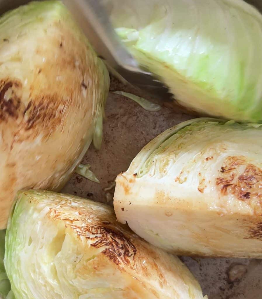 browning cabbage in butter in a dutch oven on the stovetop