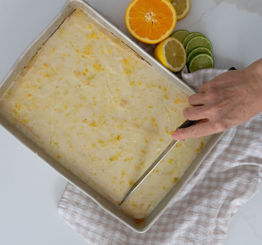 cutting citrus bars in a baking pan 