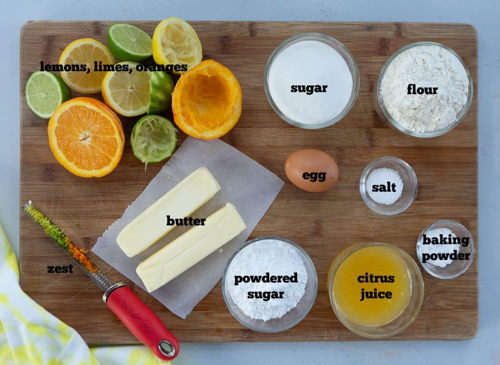 ingredients for citrus bars on a wood cutting board
