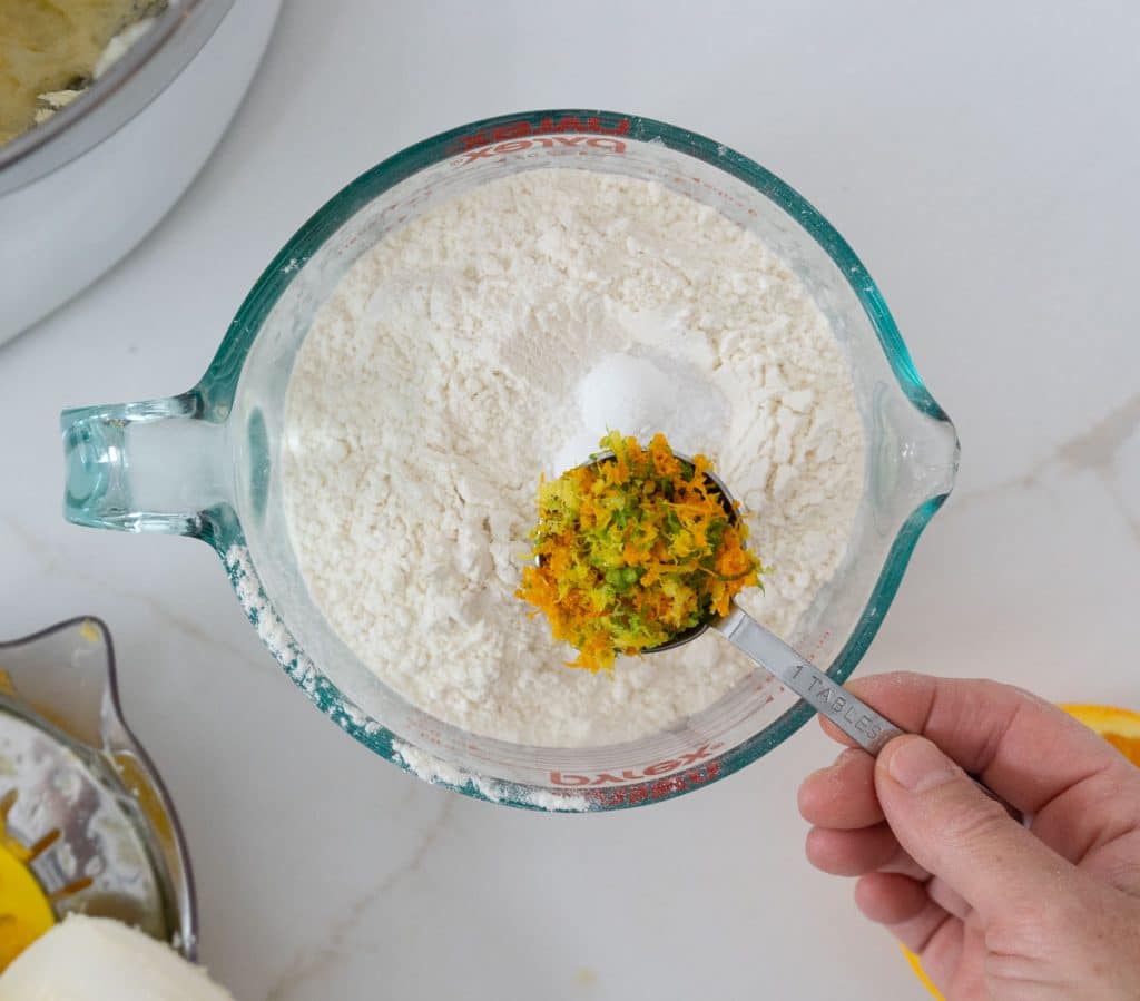 adding citrus zest to flour mixture