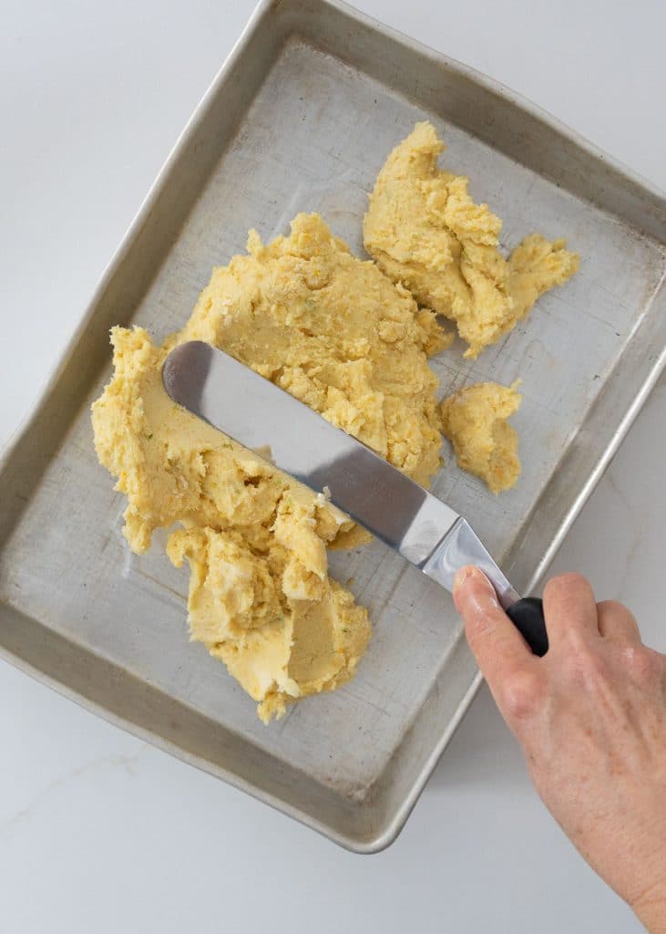 spreading dough into 9x13 baking pan