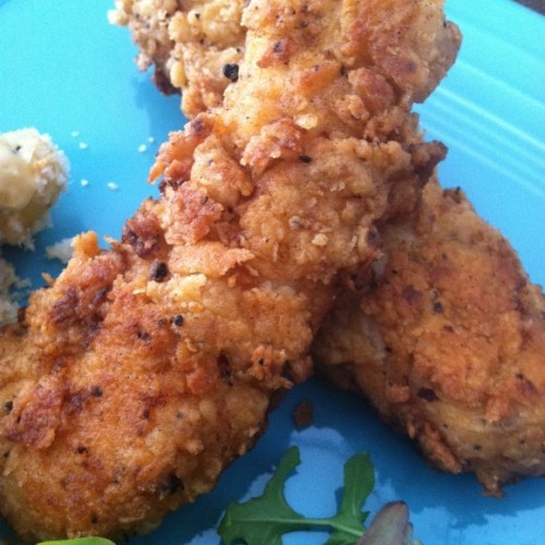 fried chicken tenders on a blue plate