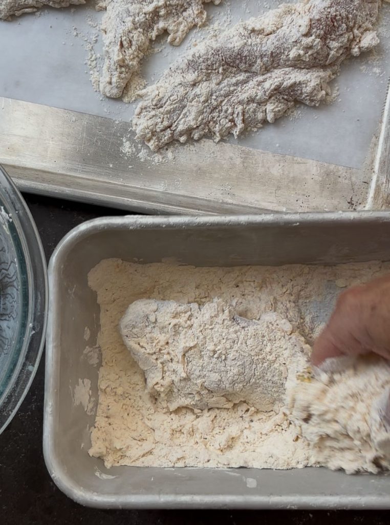 dredging chicken tenders in flour 