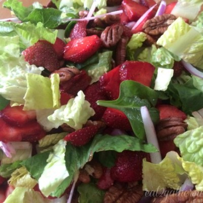 Romaine lettuce salad with strawberries, pecans, and poppy seed dressing
