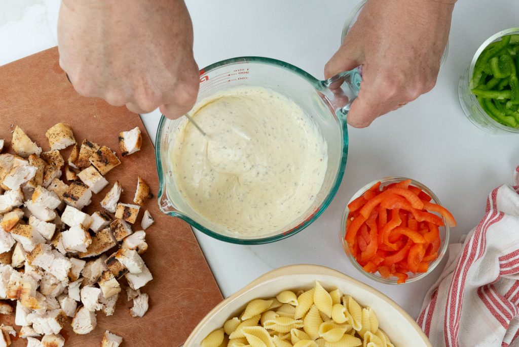whisking salad ingredients together