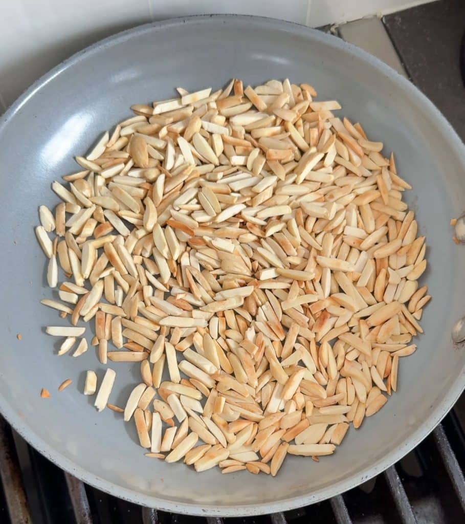 toasting slivered almonds in a  pan on the stovetop