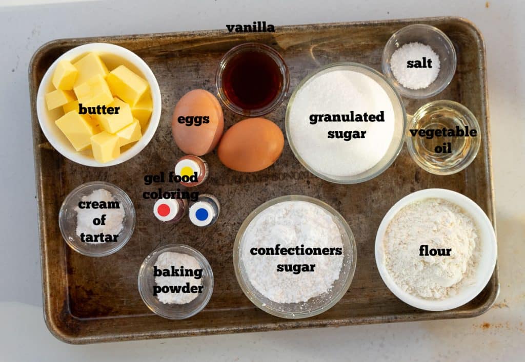 photo of ingredients for sugar cookies on a cookie sheet on a white countertop