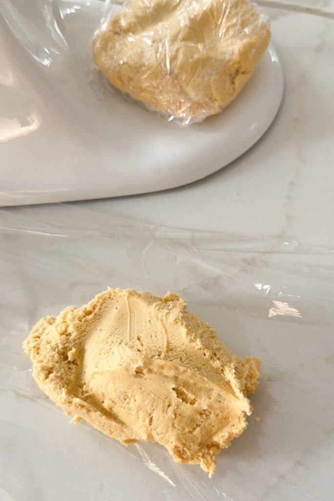wrapping cookie dough up in plastic wrap to be refrigerated