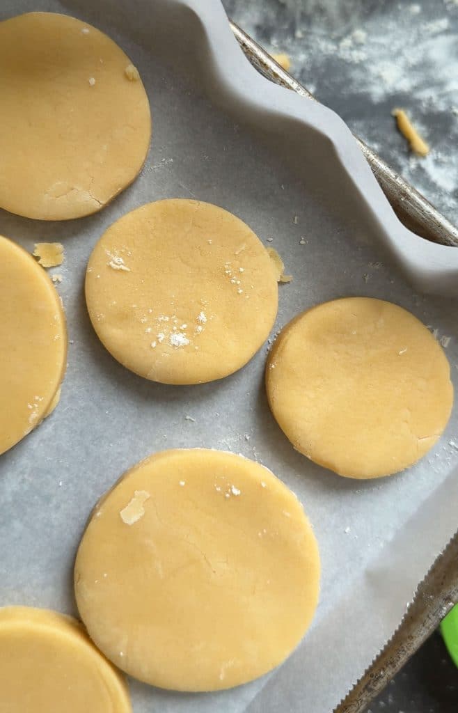 cut out cookie dough on a baking sheet lined with parchment paper