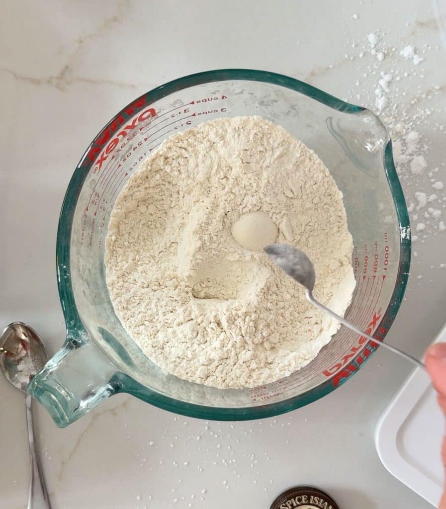 dry ingredients in a glass measuring cup on a white countertop