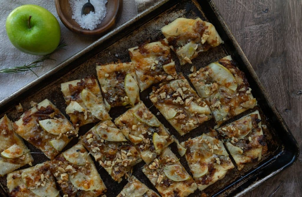 Apple and Cheddar Rosemary and walnut flatbread on a sheet pan