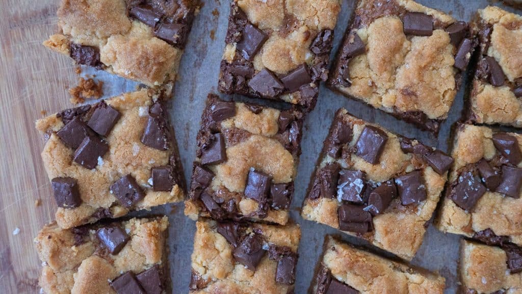 pan full of  cut salted caramel chocolate chunk cookie bars