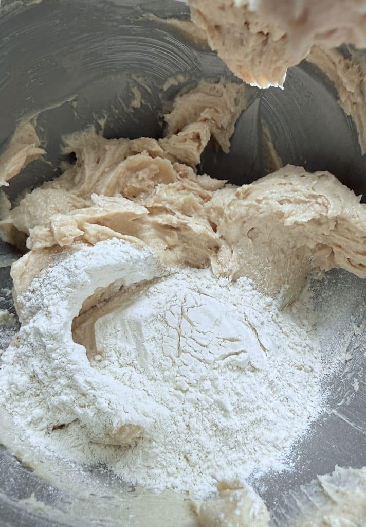 ingredients for salted caramel bar shortbread dough in stand mixer bowl. flour added