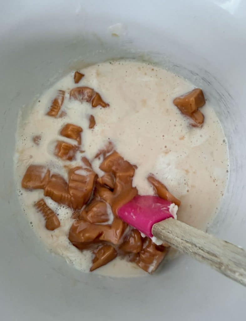 unwrapped caramels in a bowl with cream