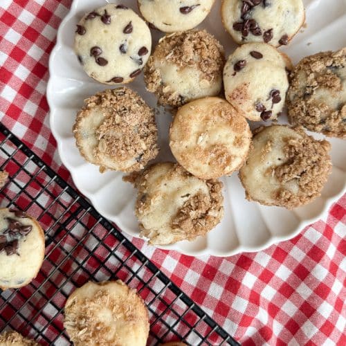 plate of mini muffins on a white plate on a red and white gingham cloth next to a cooling rack of mini muffins