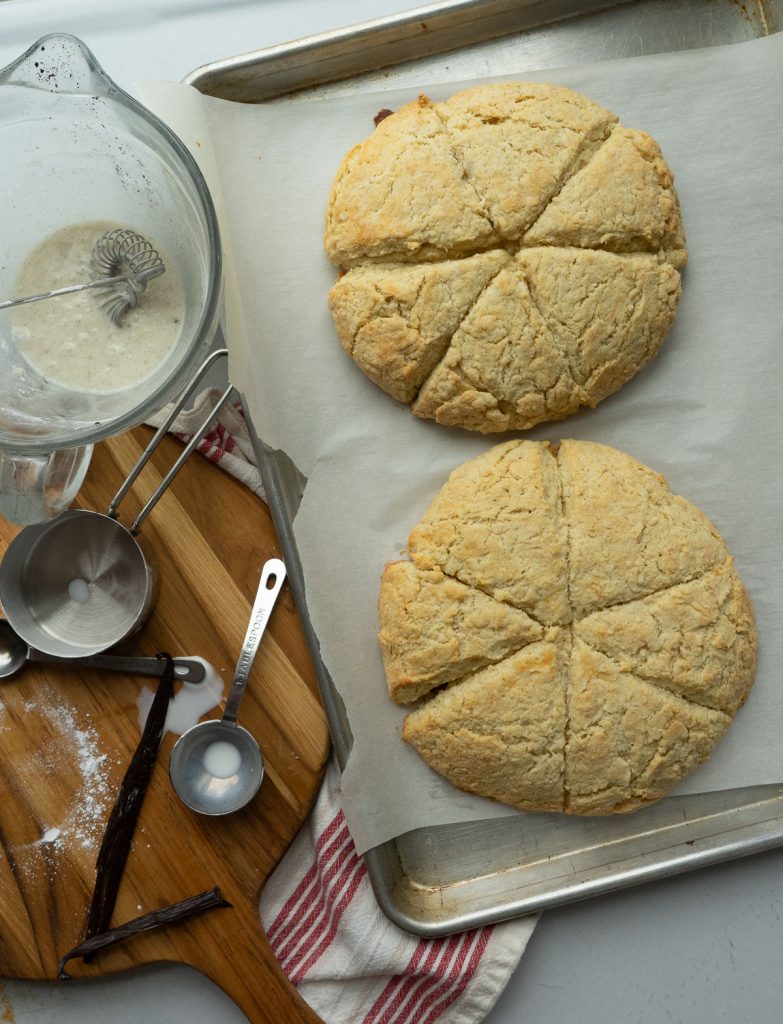 scones on a baking sheet with icing ingredients off to the side