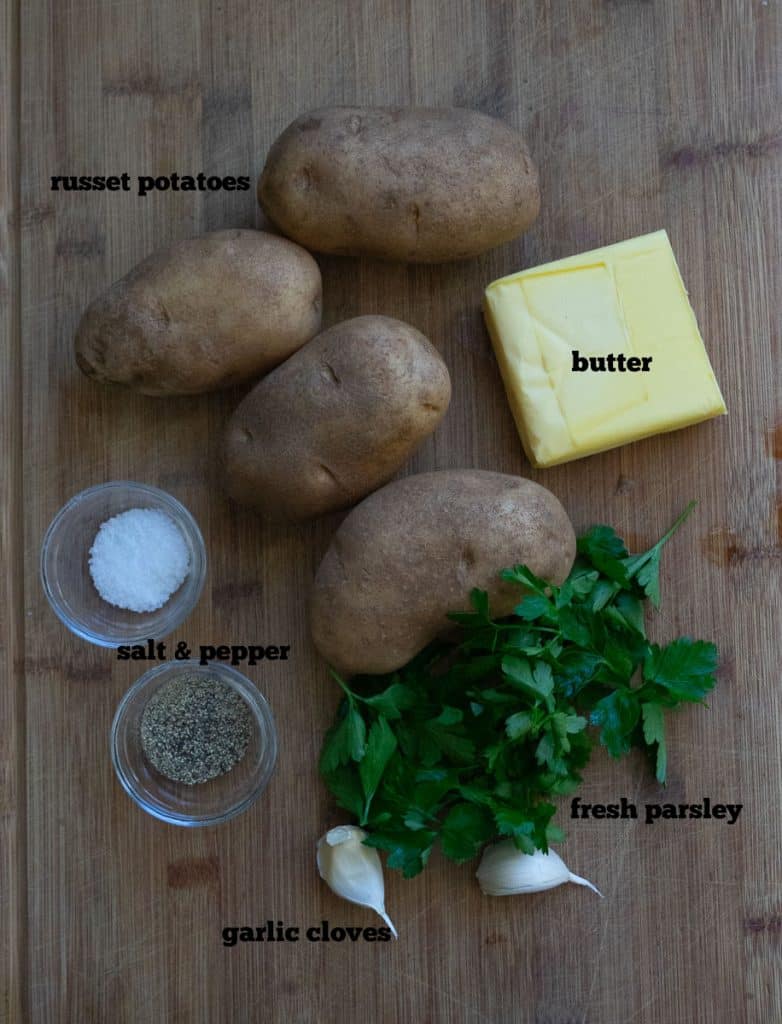 photo of ingredients for hasselback potatoes on a wood cutting