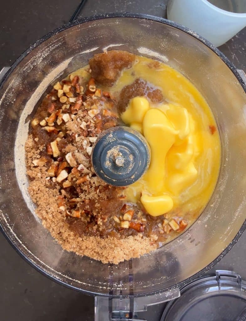 adding butter and brown sugar to the crush pretzels in the food processor