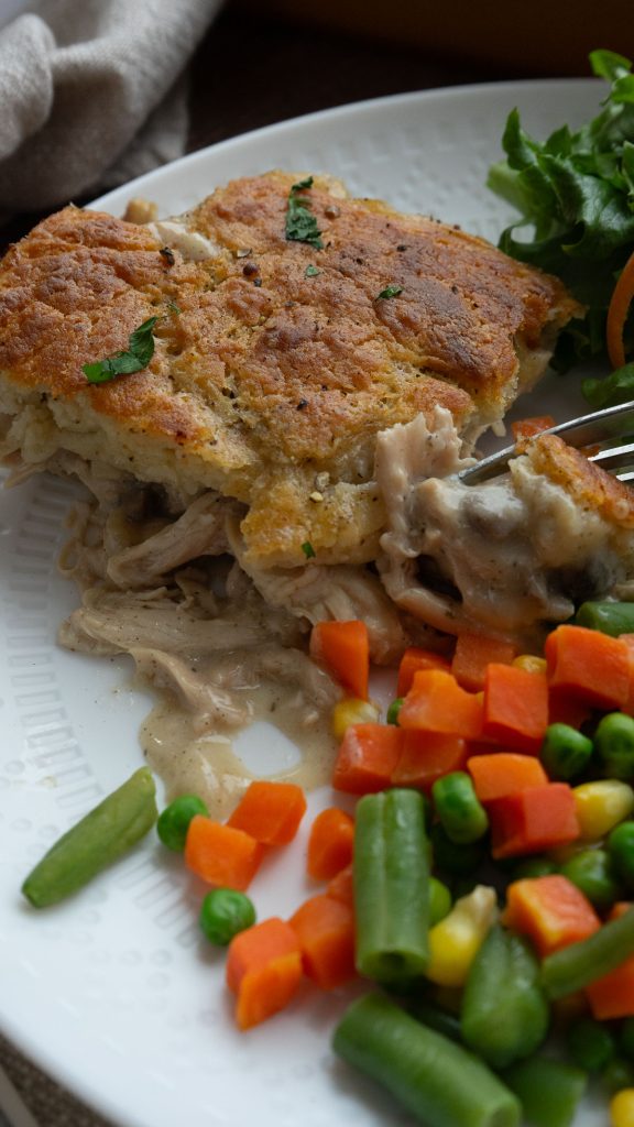 chicken pie on a plate with mixed veggies