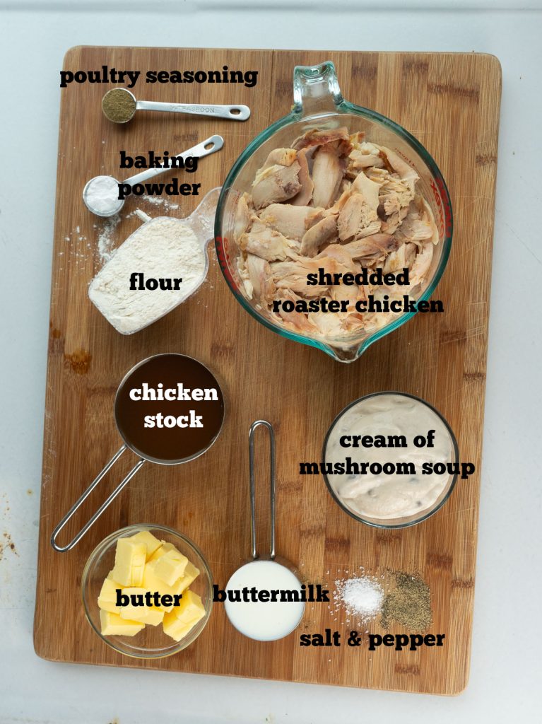 ingredients for chicken pie on a wood cutting board on a gray background