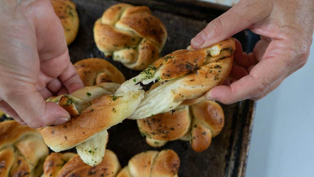 pulling apart a baked garlic knot