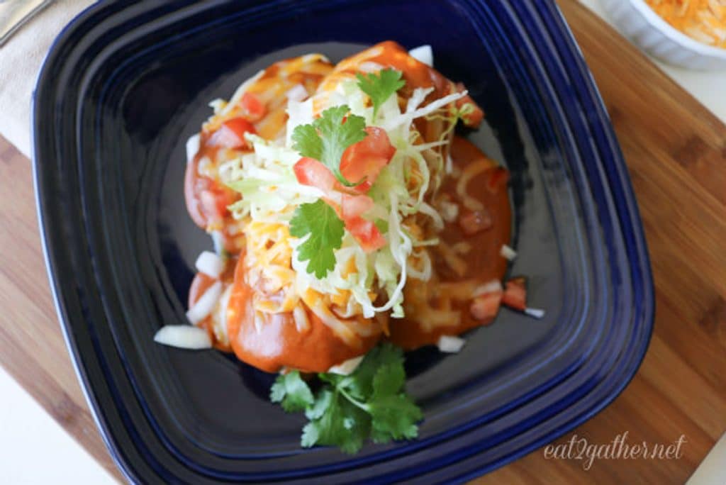 arial view of wet burrito on a blue plate with all the fixins
