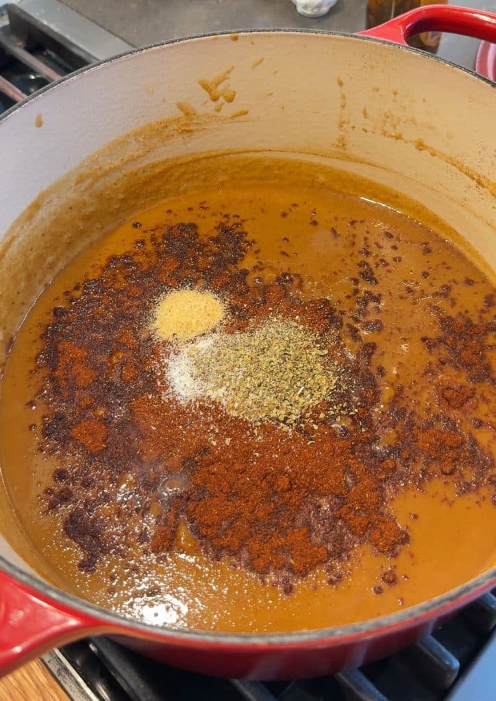 adding spices to the sauce