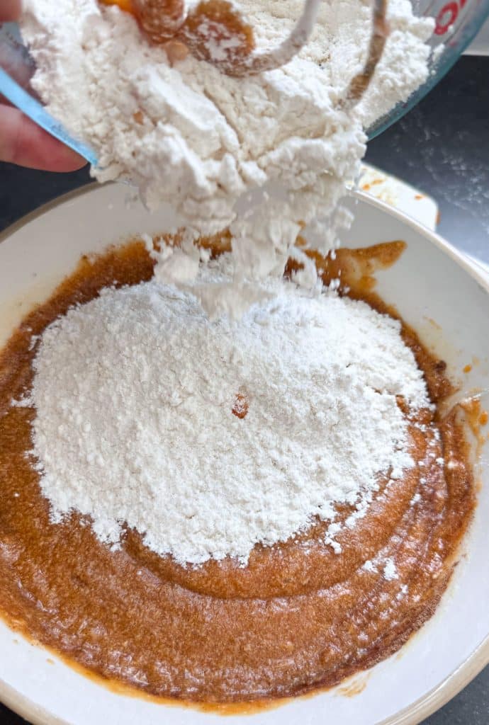 adding flour to pumpkin mixture