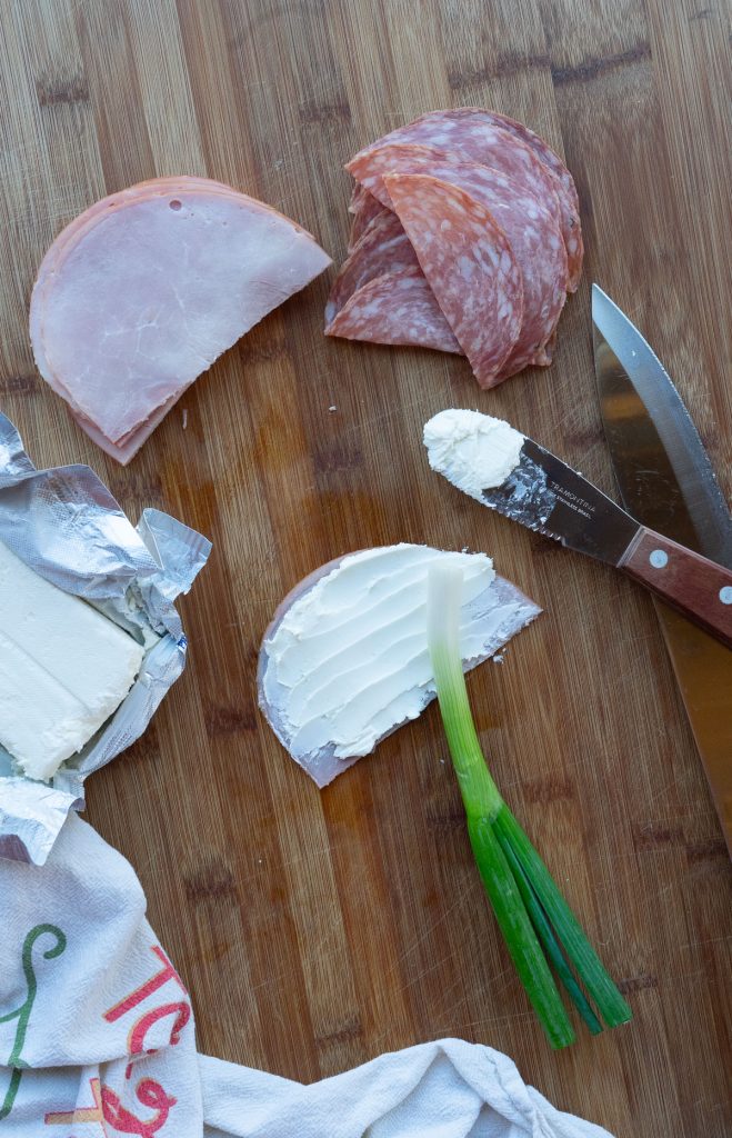 ham spread with cream cheese and a green onion, assembly of ham roll ups