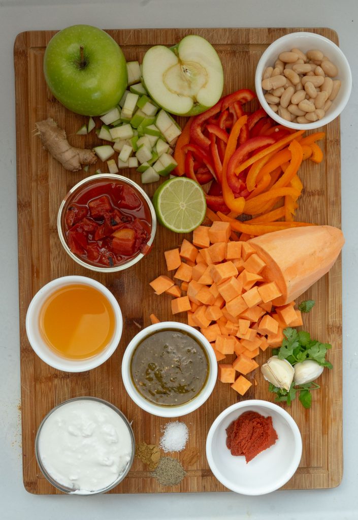 ingredients for soup laid out on a wood cutting board