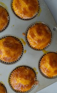 orange kissed muffins in muffin tin