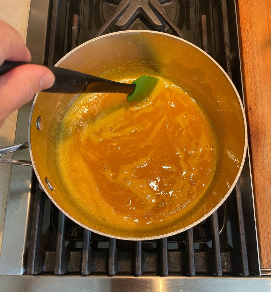 reducing orange juice concentrate in sauce pan over low heat stirring with a small spatula