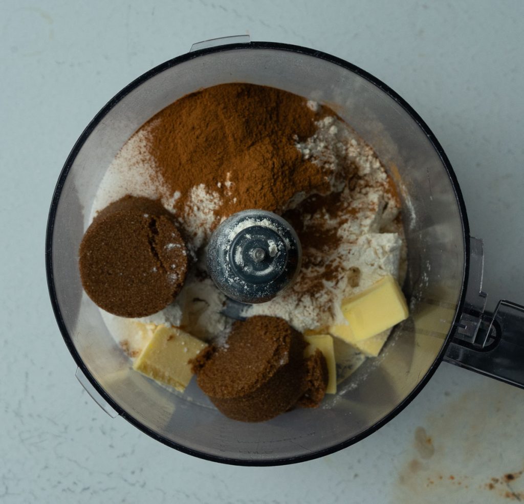 streusel ingredients in food processor viewed from the top on a white counter